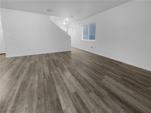 unfurnished living room featuring dark wood-type flooring