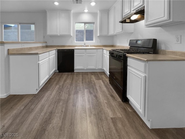 kitchen with sink, black appliances, white cabinetry, and dark hardwood / wood-style floors