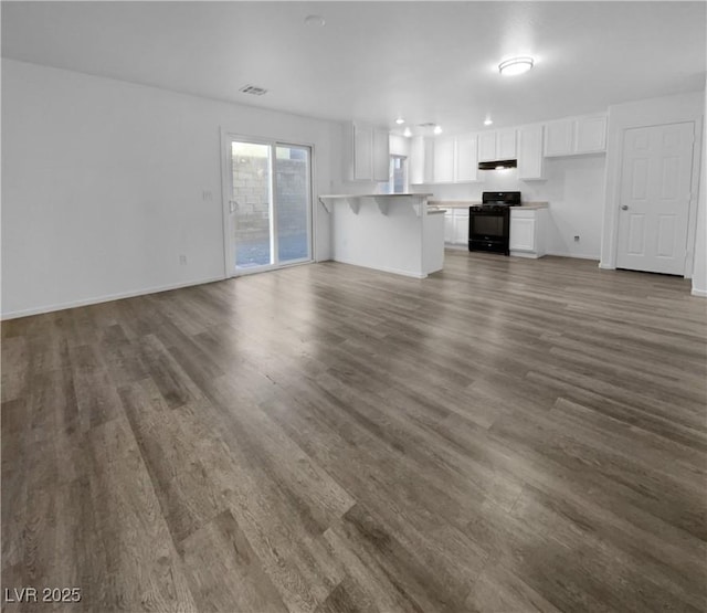 unfurnished living room with dark hardwood / wood-style floors