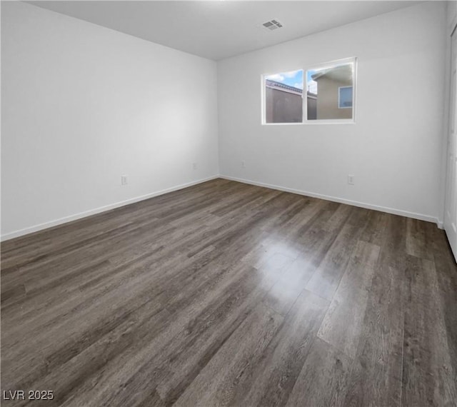 empty room featuring dark hardwood / wood-style flooring