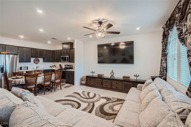 tiled living room with sink and ceiling fan