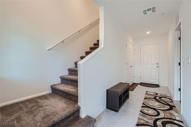 stairs featuring tile patterned floors