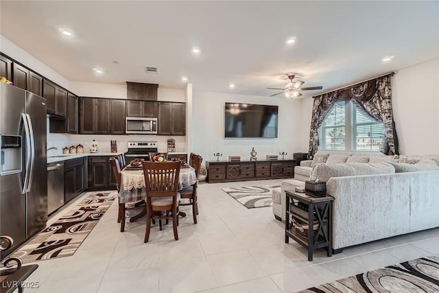 tiled living room featuring sink and ceiling fan