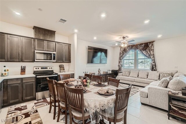 tiled dining space with ceiling fan