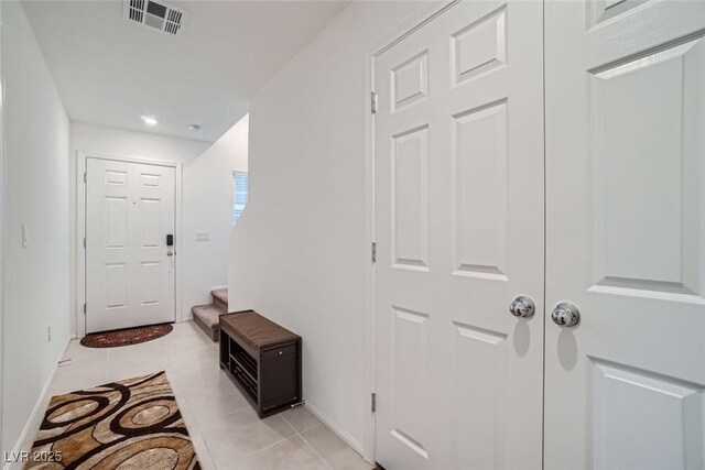 entryway with light tile patterned floors