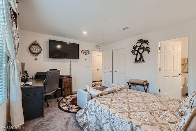 carpeted bedroom featuring ensuite bathroom