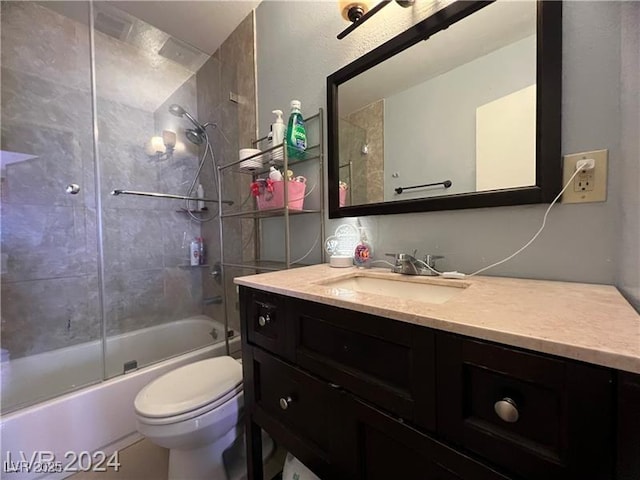 full bathroom featuring bath / shower combo with glass door, vanity, and toilet