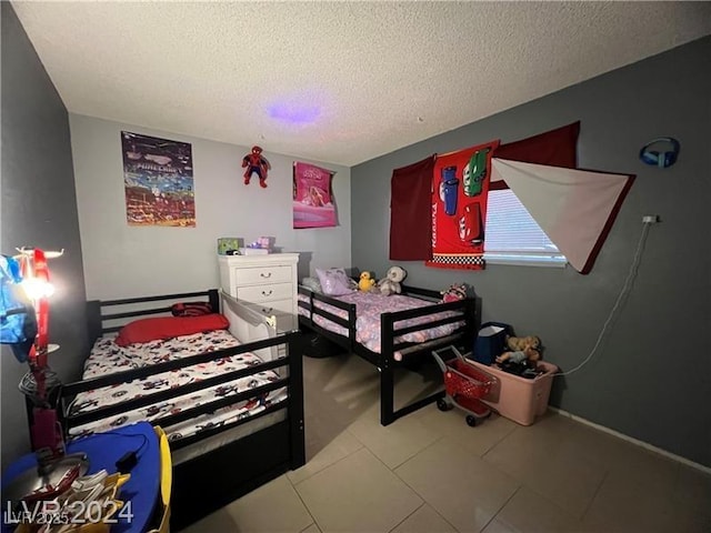 bedroom featuring light tile patterned floors and a textured ceiling