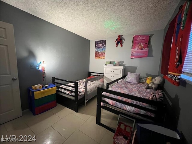 tiled bedroom with a textured ceiling