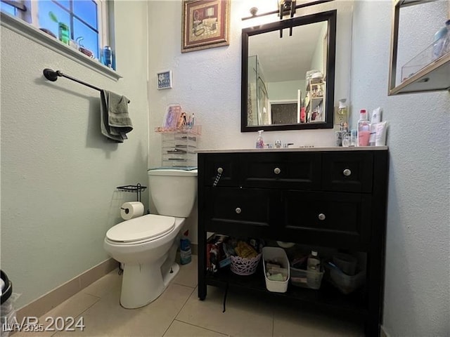 bathroom featuring vanity, tile patterned floors, and toilet