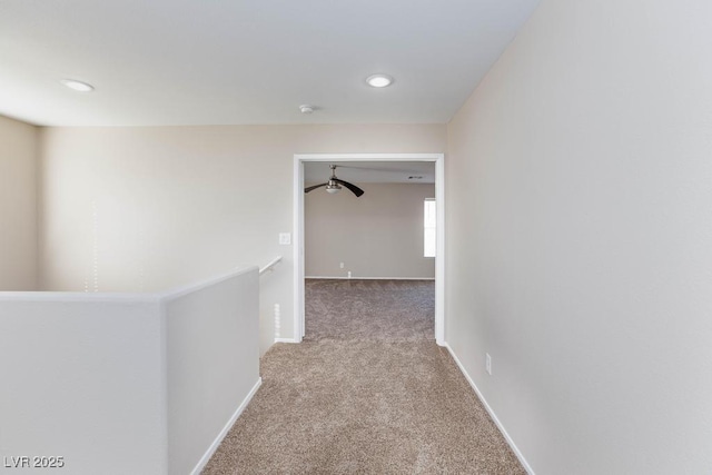 hall featuring baseboards, carpet flooring, an upstairs landing, and recessed lighting