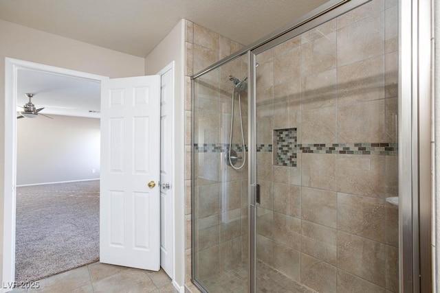 full bath with tile patterned flooring, a stall shower, and ceiling fan