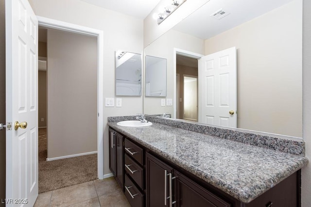 bathroom featuring baseboards, vanity, tile patterned floors, and visible vents