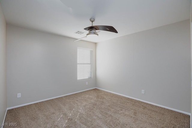 carpeted empty room featuring visible vents, a ceiling fan, and baseboards
