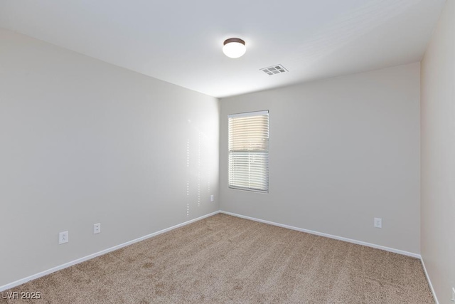 carpeted spare room with baseboards and visible vents