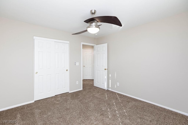 unfurnished bedroom featuring carpet floors, a closet, baseboards, and ceiling fan
