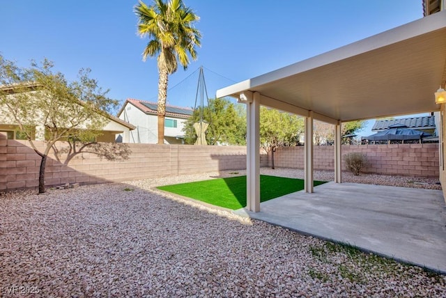 view of yard featuring a patio area and a fenced backyard