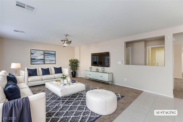 carpeted living area featuring tile patterned floors, baseboards, and visible vents
