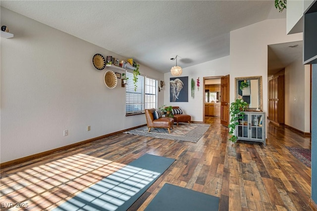 interior space with dark hardwood / wood-style flooring and lofted ceiling