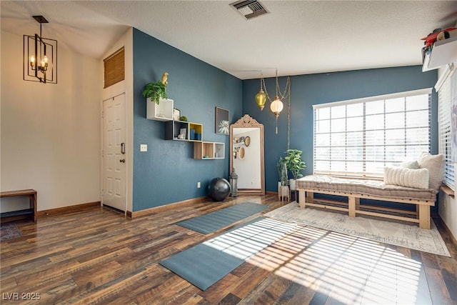 interior space with a chandelier, dark hardwood / wood-style floors, and vaulted ceiling