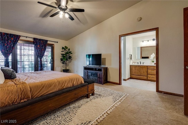 bedroom featuring ceiling fan, sink, light colored carpet, connected bathroom, and lofted ceiling