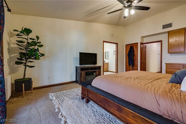 carpeted bedroom featuring ceiling fan and ensuite bathroom