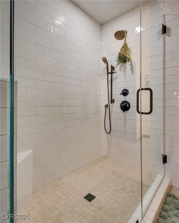 bathroom with a shower with door