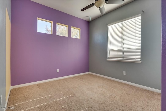 empty room featuring ceiling fan and light carpet