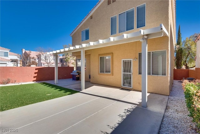 back of property featuring a lawn and a patio