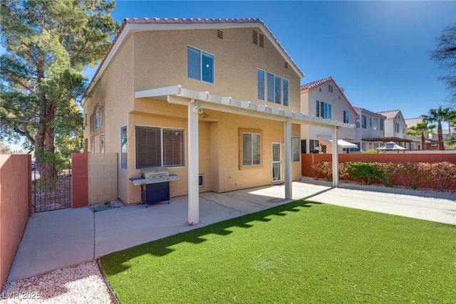 back of property with a patio area and a lawn