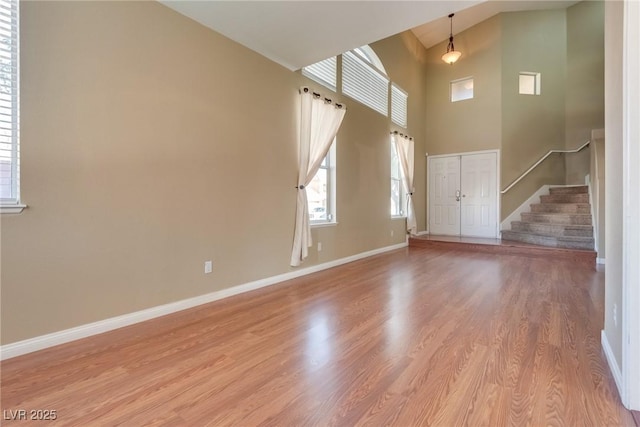 foyer with light hardwood / wood-style flooring and a high ceiling