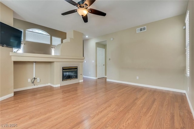 unfurnished living room with light hardwood / wood-style flooring and ceiling fan