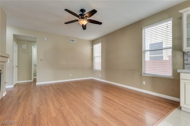 unfurnished living room featuring light hardwood / wood-style floors and ceiling fan