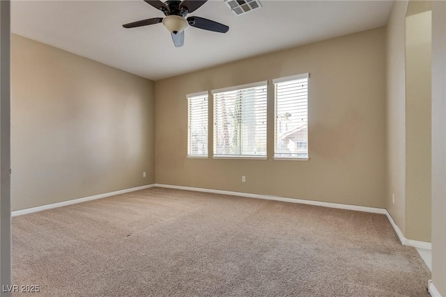 spare room featuring carpet flooring and ceiling fan