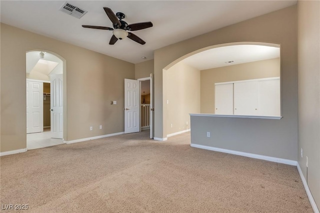 empty room featuring light carpet and ceiling fan