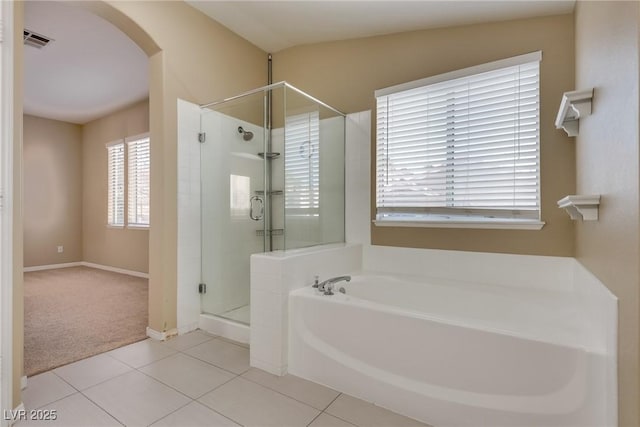 bathroom with shower with separate bathtub, lofted ceiling, and tile patterned flooring