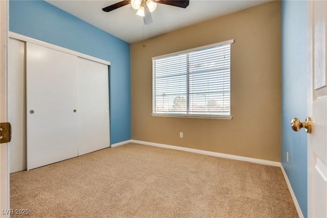 unfurnished bedroom with a closet, ceiling fan, and light colored carpet