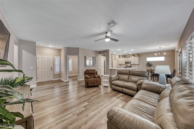 living room with light wood-type flooring and ceiling fan