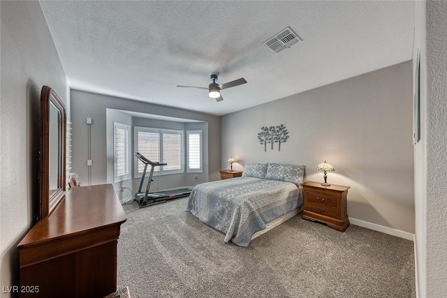 bedroom featuring a textured ceiling, carpet floors, and ceiling fan