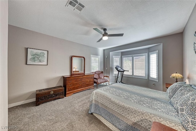 bedroom featuring ceiling fan, a textured ceiling, and carpet floors