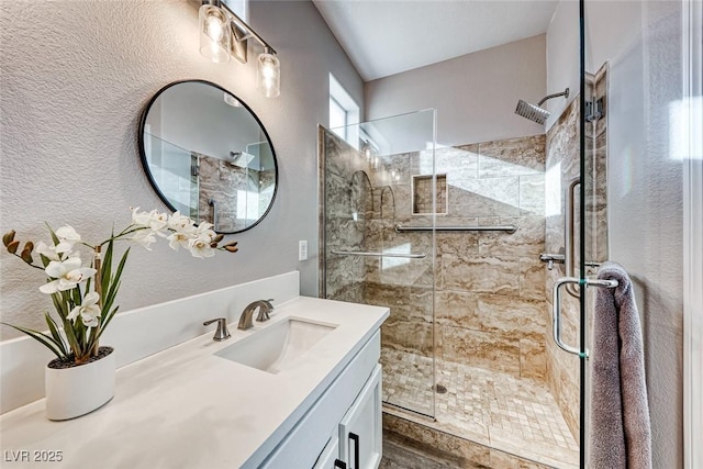 bathroom with an enclosed shower and vanity