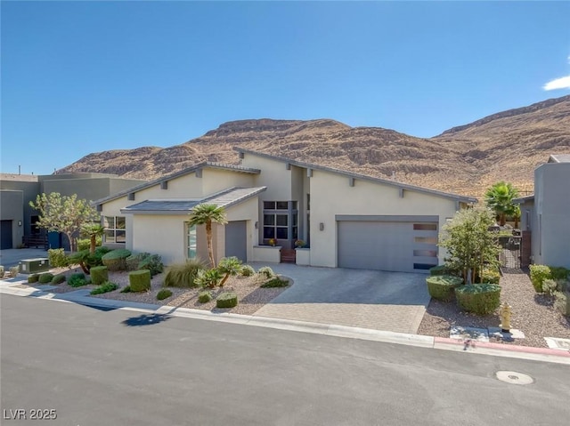 view of front of property featuring a mountain view and a garage