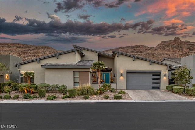 view of front of house with a mountain view and a garage