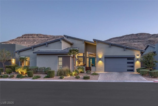 contemporary home featuring a mountain view and a garage