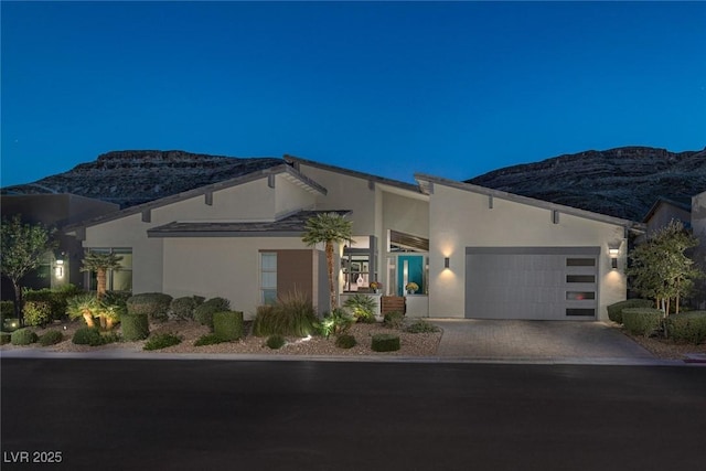 view of front of home with a mountain view and a garage