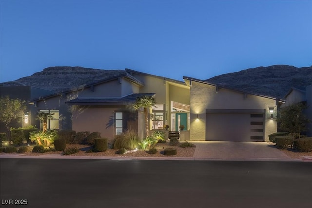 view of front of home featuring a mountain view and a garage