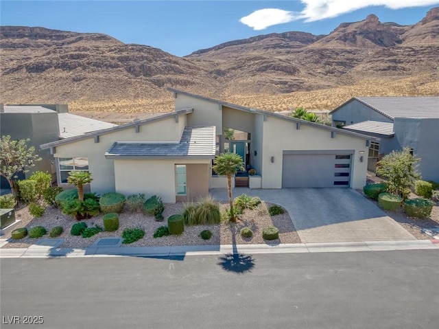 view of front of property with a mountain view and a garage