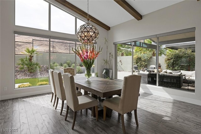 dining space featuring hardwood / wood-style floors, beamed ceiling, and high vaulted ceiling