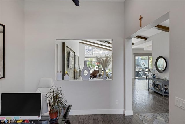 corridor with hardwood / wood-style flooring and beam ceiling