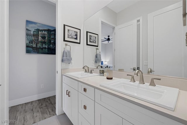 bathroom with wood-type flooring, ceiling fan, and vanity